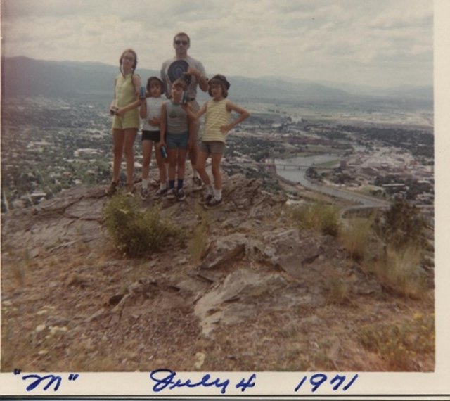 Dad and daughters on mountain top