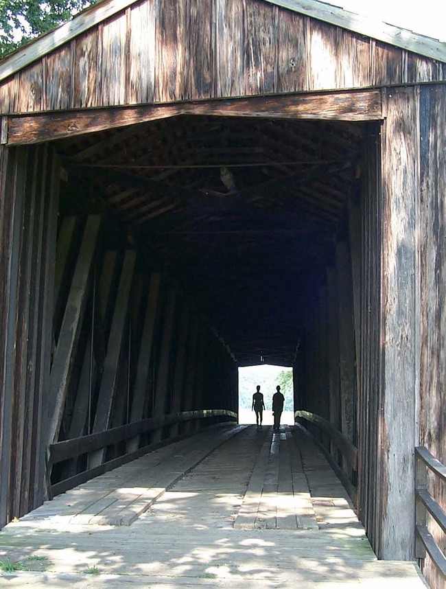 People walking across Burfordville Bridge