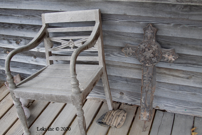 Cross, chair, baseball glove on porch of Hammond Mill