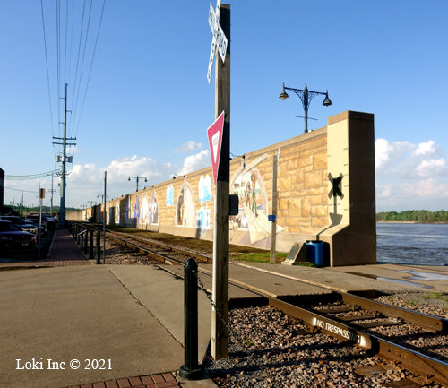 Mural wall with river through a floodgate