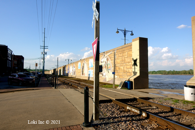 Mural wall with river through a floodgate