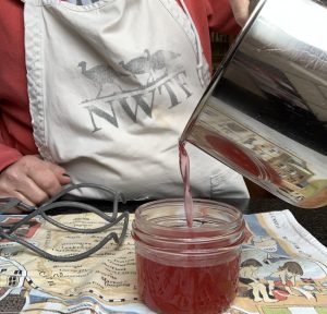 Pouring jellly redbud into jars