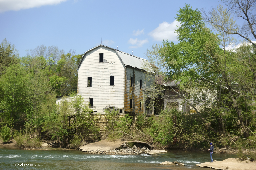 Cedar Hill Mill and man fishing from dam