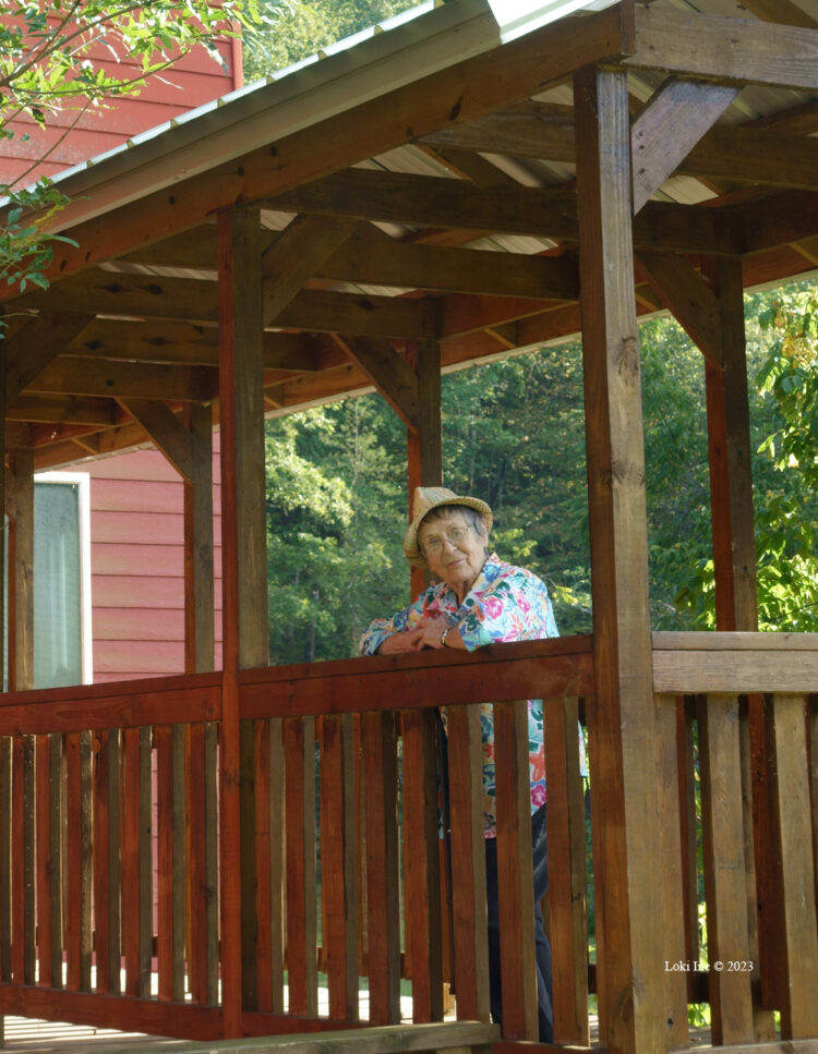 Rita Fancher leaning on railing at Rockbridge Mill